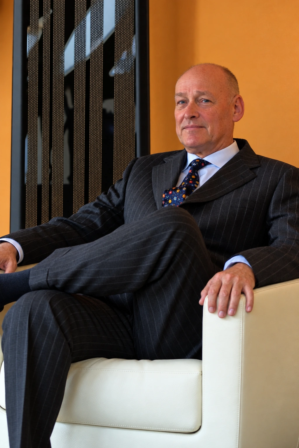 Maarten Smits seated beside a Final electrostatic loudspeaker; color restoration of an archive portrait